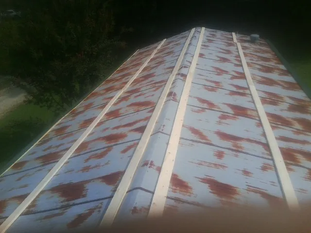 Rusted metal roof panels with new wood purlins before replacement — Storm Damage Roof Repair in Spring Branch by Roofing Brothers